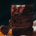 stack of vegan zucchini brownies with bite out of top brownie