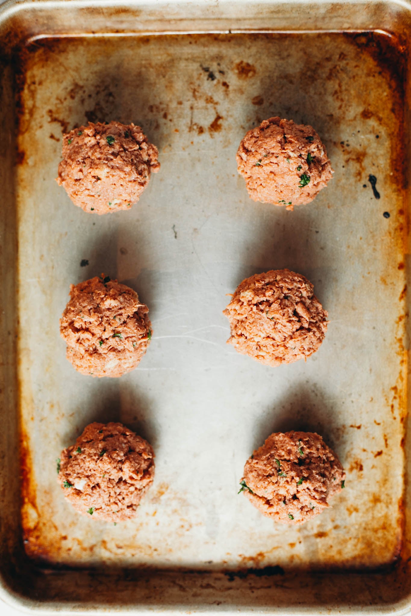 photo of 6 vegan meatball son a baking sheet