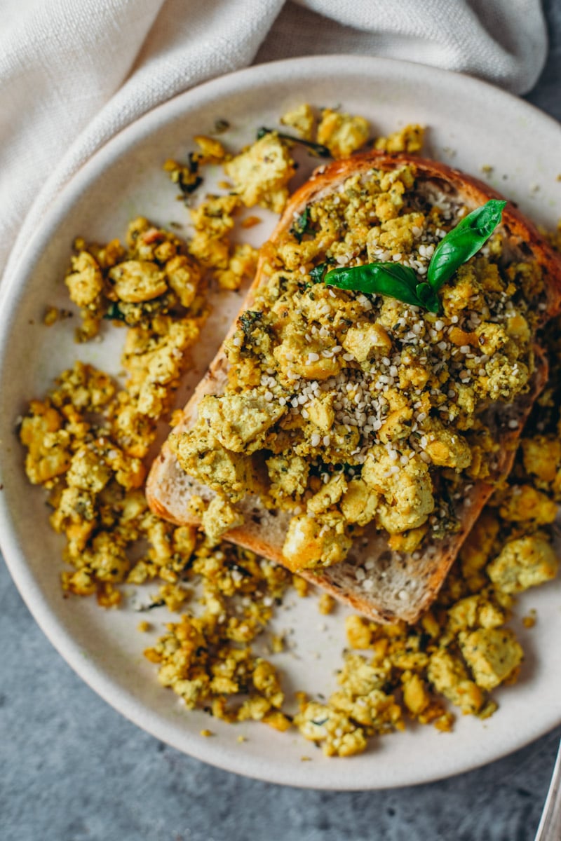 food photography of savoury high protein vegan tofu scramble on toast.