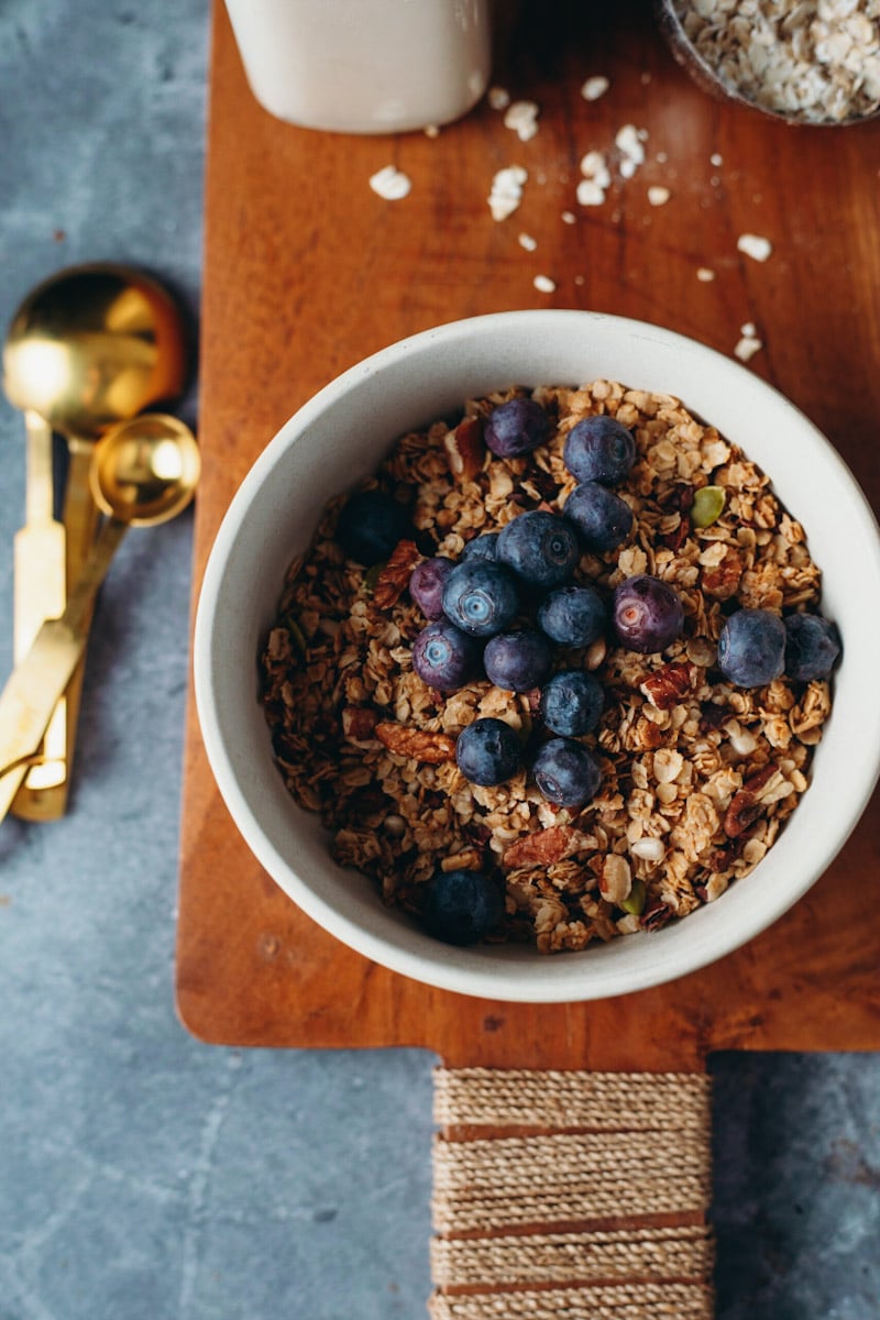 overhead of vegan granola in a bowl with blueberries