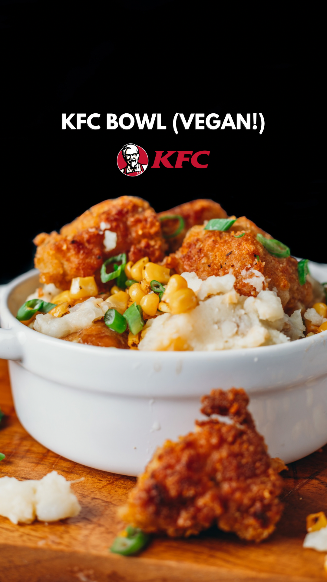 front on look of a pile of mashes potatoes, gravy, corn and vegan fried chicken bites in a white oven baking dish. "KFC Bowl (Vegan!)" and logo written over top.