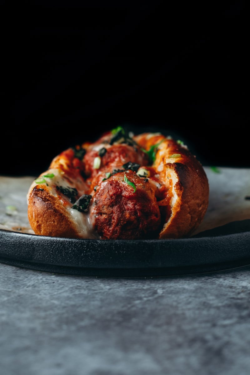 front facing picture of a cheesy Vegan meatball sub with frozen meatballs.