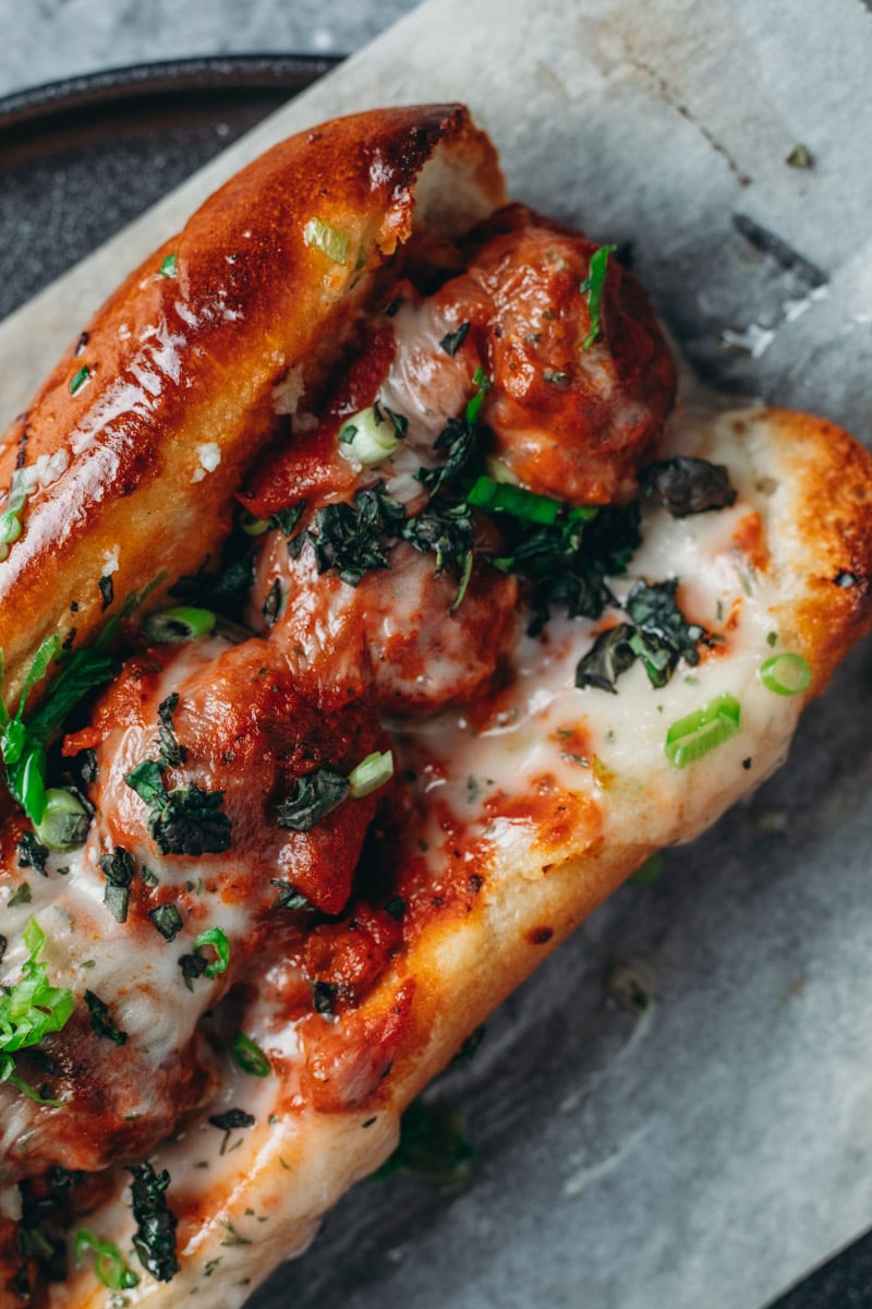 overhead picture of a cheesy Vegan meatball sub with frozen meatballs.
