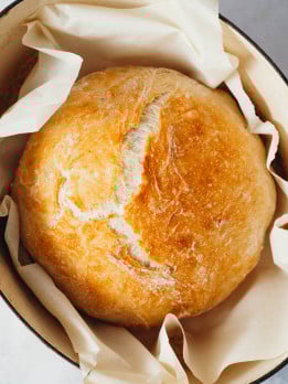 overhead view of golden brown bread in a crockpot after being baked.