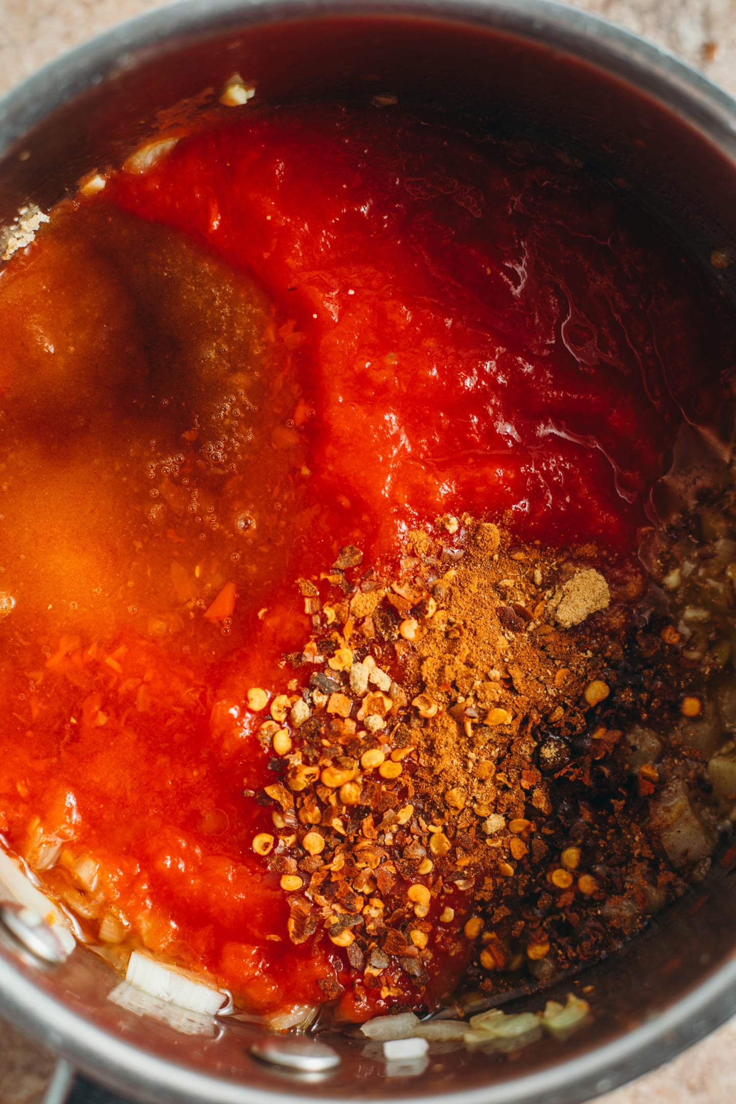 overhead view of spics poured into pot.